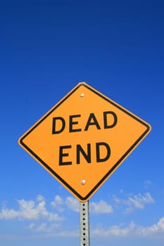 Dead end road sign over blue sky.
