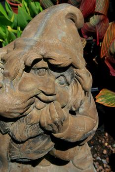 Close up of a small garden gnome.
