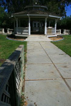 Close up of a white gazebo in a garden.
