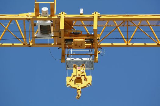 Pulley on a crane on a blue sky background