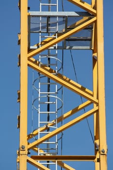 Ladder on a crane on a blue sky background