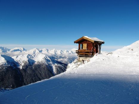 Mountain top cabin/hut perched precariously on the side of a mountain