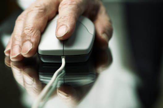 hand of the man with computer mouse,focus point on the finger,special tone photo f/x