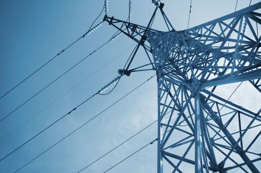 high-voltage line on the sky background,special blue toned photo f/x with vignetting,selective focus
