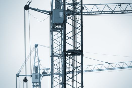 special blue photo toned f/x with dark vignetting,focus on the nearest part of crane