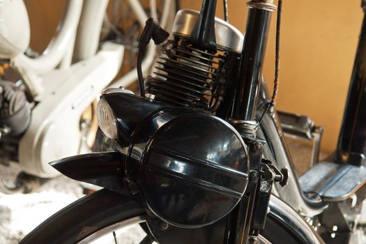 Closeup details of an old vintage retro black scooter moped