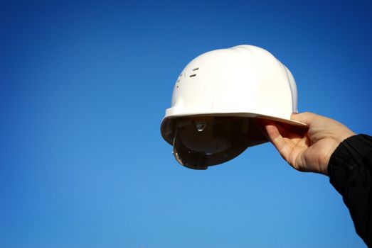 white hard-hat, special blue vignetting focus on the hand