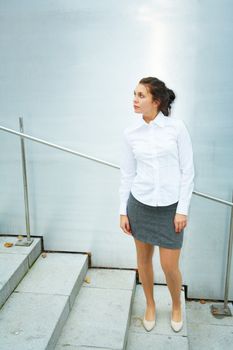 Young woman standing on stairs