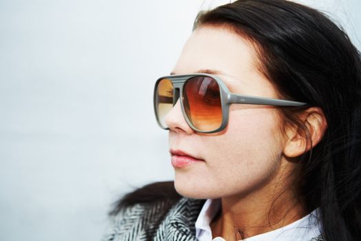 Young woman wearing plastic retro sunglasses