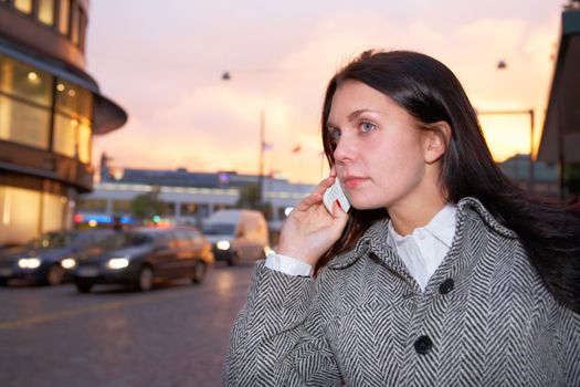 Young woman using mobile phone in street