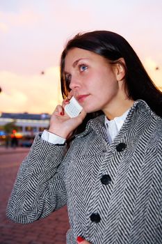 Young woman using mobile phone in street