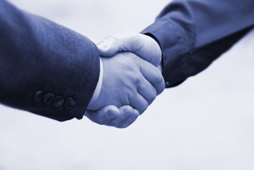 two hands (special toned, focus point on hand of nearest businessman)