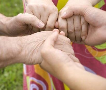 family concept (focus point on hands of the woman)
