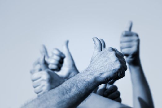 hands of the people with OK signs (special toned,focus point on nearest hand of the man)