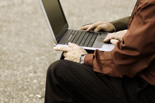 two businessmen with computer outside