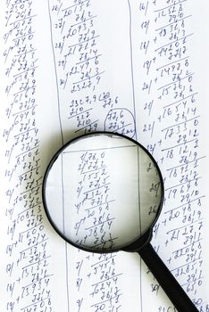 papers and magnifying glass, focus point on center of photo
