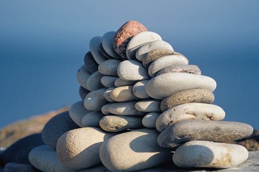 Mass of sea pebbles on a blue background