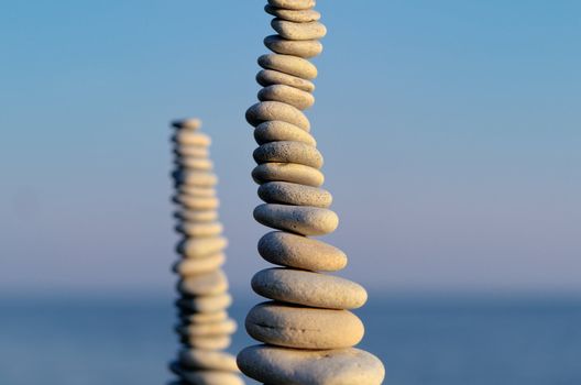 Two pile of pebbles in the balance on the seacoast
