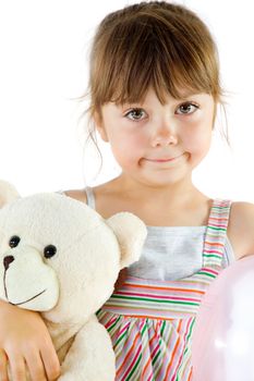 Portrait of a sweet little girl cuddling a teddy bear, isolated on white