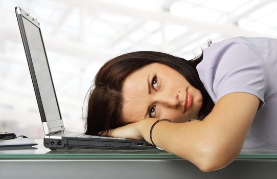 portrait of a girl resting with his head on a laptop