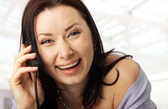 close-up of a happy female face with a cellphone