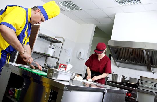 Two cooks preparing delicious pastry