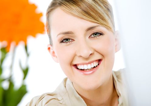 Portrait of beautiful smiling happy blond business woman, looking at camera
