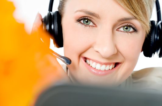 Portrait of beautiful smiling call center woman, looking at camera
