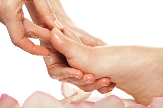 woman foot receiving gentle massage in a spa setting isolated