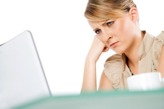 Portrait of beautiful blond woman behind laptop, looking upset or worried