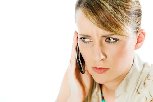 face of beautiful blond woman talking on the phone, looking worried