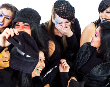 Seven dressed for halloween witches with faceart laughing and having fun