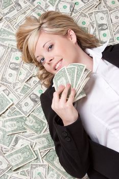 Smiling woman laying in money