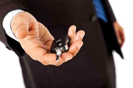 Close-up of male hand offering a car key