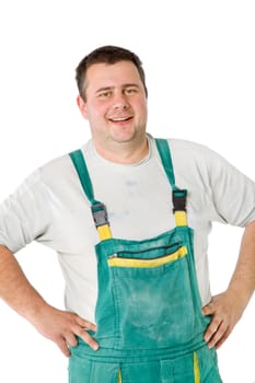 Close-up of smiling male worker posing with arms on waist, isolated