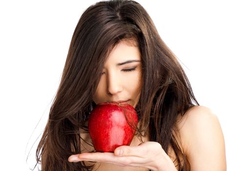 Close-up of beautiful topless female smeling red apple, eyes closed