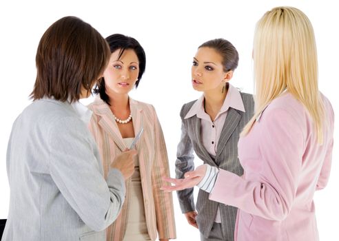 Team of four businesswomen looking serious in conversation, isolated on white