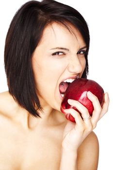 Beautiful topless female aggressively biting a red apple