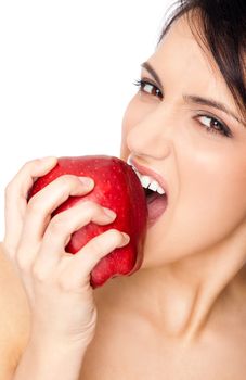 Close-up of beautiful topless female biting agressively red apple, coppyspace