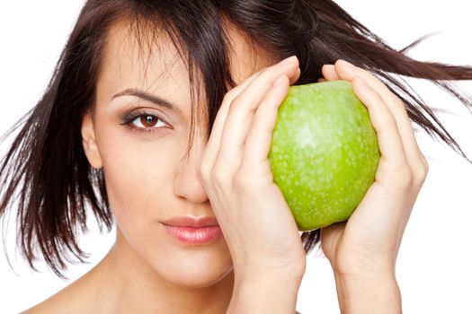 Beautiful young woman holding a granny smith apple