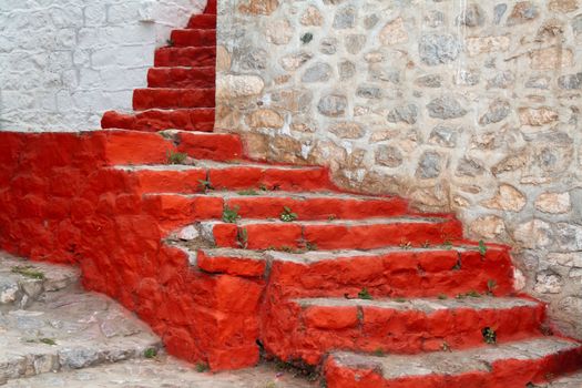 Old stone staircase painted in red, Greece