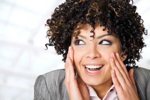 beautiful curly woman face smiling, hands on her cheeks