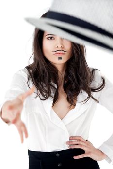 Beautiful young female with moustache dendy makeup throwing hat
