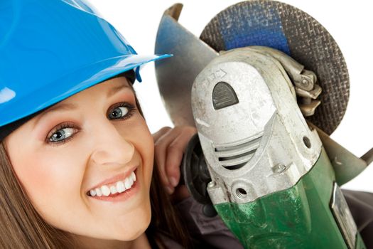 Close-up of beautiful happy female with blue hardhat holding grinder next to her face