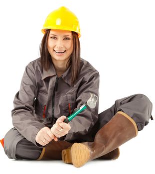 female construction worker sitting and holding a claw hammer, isolated on white