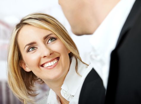 Face of a beautiful white collar female worker smiling at her partner