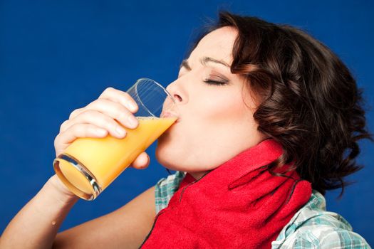 young woman drinking orange juice in pain being strangled by the throat