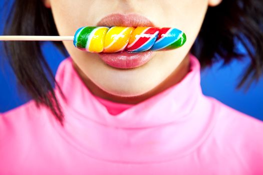 Close-up of a girl's mouth licking a lollipop