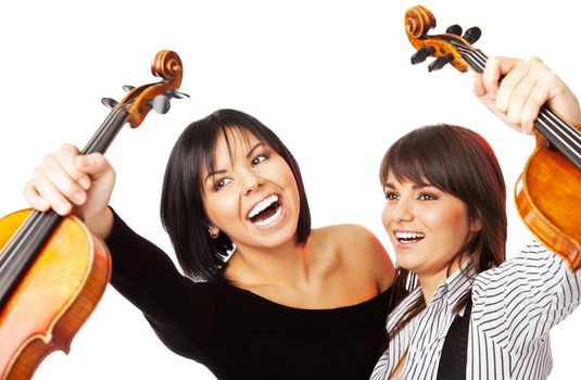 Two young excited female graduates holding up violins