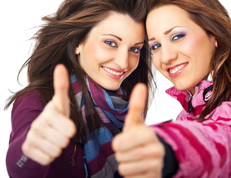 two beautiful girls smiling and showing thumbs up